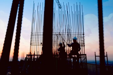 Burred of construction of rooftop high rise building, workers are tied with steel bars for concrete...