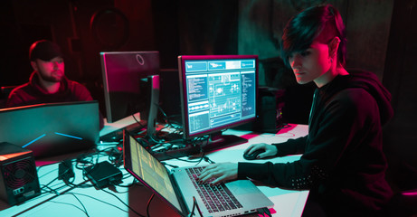 Wanted hackers coding virus ransomware using laptops and computers in the basement. Cyber attack,...