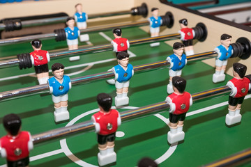 Vintage Foosball, Blue and Red Players Team in Table Soccer or Football Kicker Game, Selective Focus. table game. Boy toy sport game concept. Soccer table is relax activities indoor for kid and family