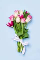 Attractive bouquet of tulips on blue background. Concept of Women's Day, Mother's Day, 8 March, the holiday greetings.