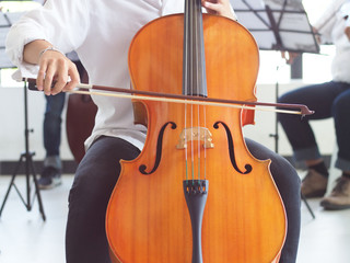 young man playing the cello © thirawat