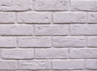 The background of the wall is a light-colored brick surface. The texture of the brick. Abstract wall background.