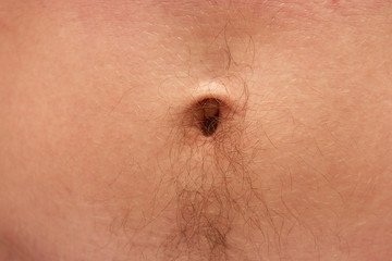 male belly button on the stomach with black hair - obrazy, fototapety, plakaty