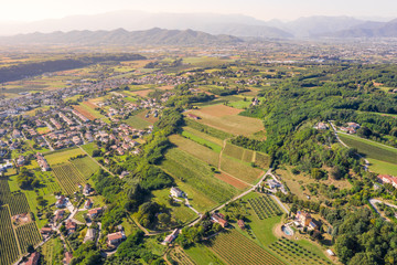 Aerial view of the vineyard-covered hills of the northern Italian countryside in a late afternoon...
