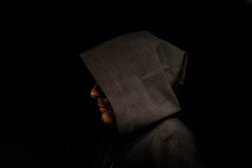 Portrait of a courageous warrior wanderer in a black cloak. Historical fantasy. Halloween