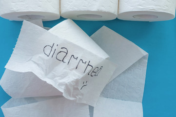 Rolls of white toilet paper labeled 