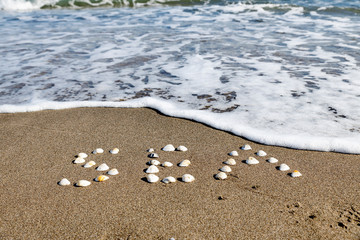 Landscape view of Black sea coast, wave reach sand shore. Summer holiday concept. 