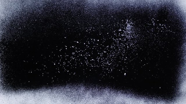 Real frost on a window. Frostwork pattern ice crystals on black background. Dark surface with abstract ice structure makes to overlay or add a frost effect.