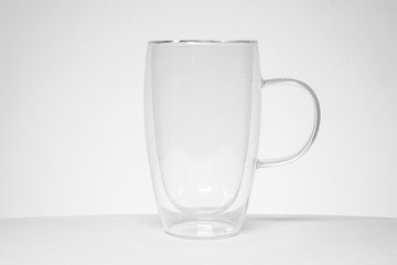 empty tea or coffee mug made of double transparent glass