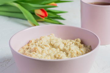 oatmeal porridge in pink ceramic bowl. healthy breakfast. close up