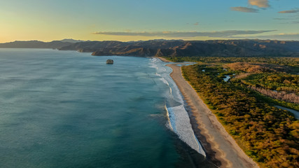 Beautiful aerial view of a sunset in  Naranjo Beach - Witch Rock Costa Rica