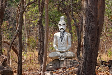 statue of buddha in the woods