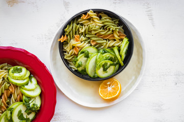 Vegan pasta with pesto, colorful macaroni with vegetables on plate. Mediterranean Italian traditional healthy food on lunch or vegetarian dinner.