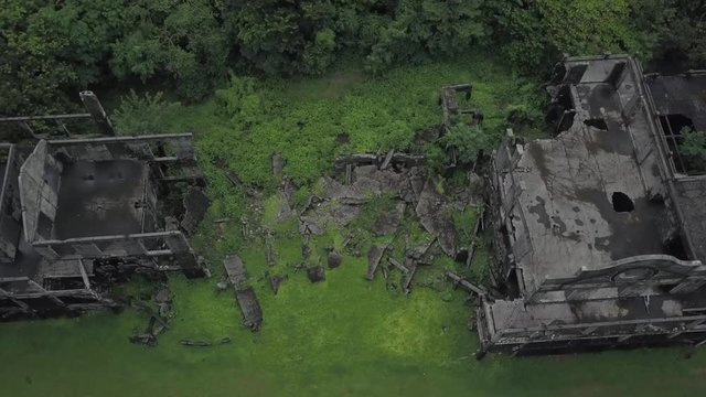 Orbiting aerial view of exploded ruins Corregidor Mike Long Barracks.