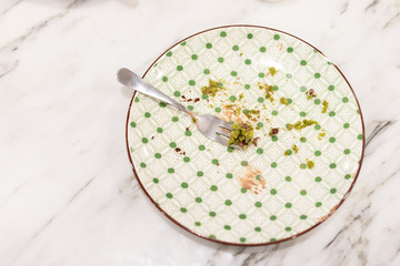 Food scraps on plates and forks.