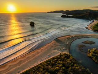 Beautiful aerial view of a sunset in  Naranjo Beach - Witch Rock Costa Rica