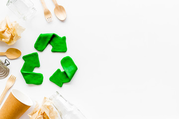 Green recycle icon near plastic, paper, glass waste on white background top-down copy space