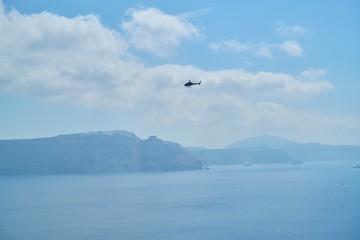 Panorama, Santorini island, ships in the sea, helicopter in sky over sea