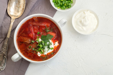 traditional Ukrainian Russian soup (borscht) from beet with greens and sour cream.