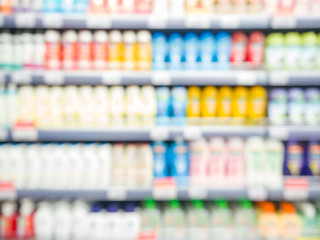 Blurred colorful supermarket products on shelves - Shampoo bottles background with shallow DOF