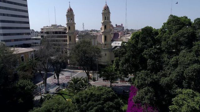 Crane-up aerial drone view move of the Cathedral at the main square of Piura city at a sunny afternoon in Piura Region, Peru