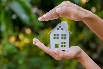 Protecting gesture of man and symbol of house.