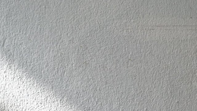 Time lapse sunrise drop shadow on old white concrete wall. 