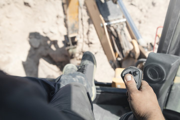 Male hand holding a control joystick. Work in excavator © andranik123