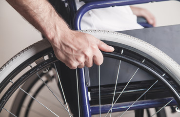 Disabled man in wheelchair in home.