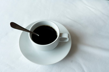 Black coffee in a white mug on the table