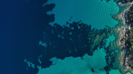 Fototapeta na wymiar Aerial view of Halkidiki lagoon, Vouvourou beach, turquoise water of Aegean sea, rocks underwater. Greece seascape.