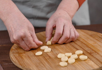 Obraz na płótnie Canvas Cook's hands kneading dough pieces