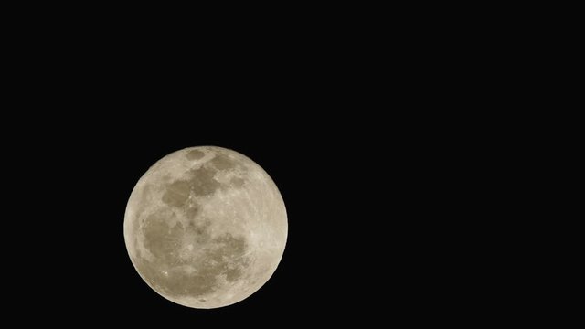 Full moon moving across the sky very fast. Night timelapse video.