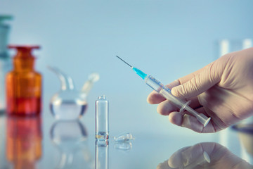 syringe with medicine in hand, for injection, close-up hospital