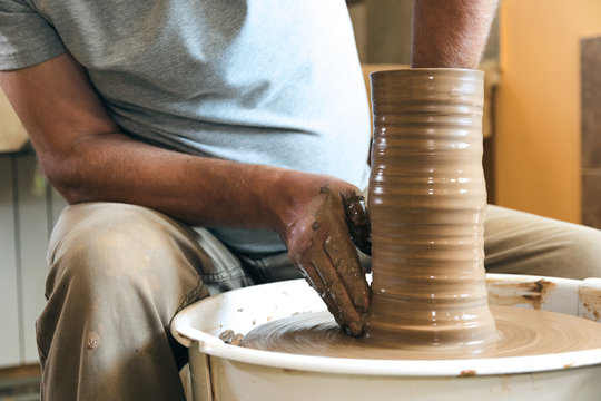 Portrait of craftsman working with clay in pottery workshop. Small business concept. - Powered by Adobe