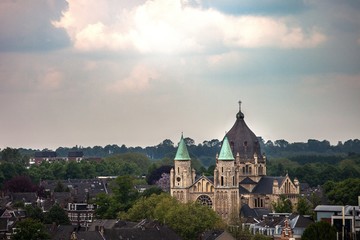 Fototapeta premium skyline of european city with large cathedral and forest