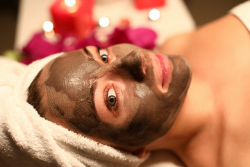 Woman put clay mask on her face waiting for result. Appreciate freshness and hydration skin. Skin around lips and eyes becomes more elastic and smooth. Restoration protective function skin