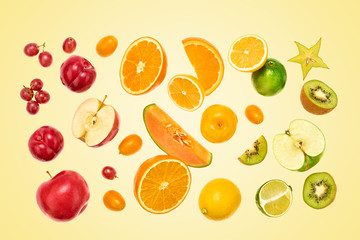 Flying Fruits healthy food summer color background. Apple, orange, kiwi, melon, plum, citrus. Colorful levitation, falling fly fruit creative vitamin concept. Fresh tropical fruit on yellow