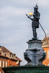 Fototapeta na wymiar hot air balloon floating past statue of charlemagne