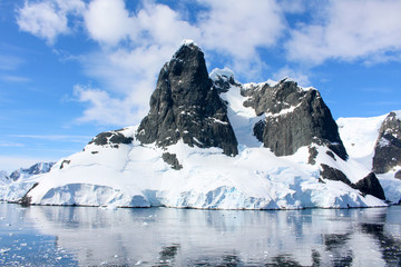 Fototapeta na wymiar Landscape of snowy mountains of the Lemaire Channel in the Antarctic Peninsula, Antarctica