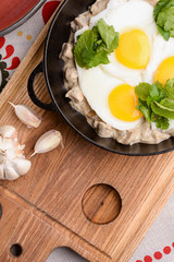 Fried egg with green spinach in pan, healthy breakfast. Healthy food.