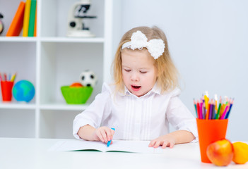 a child  girl  doing homework writing and reading at home