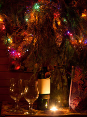 Still life with a bottle of wine with a blank label and two glasses on a on a dark colourfull background