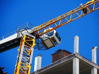 Fototapeta premium Crane. Self-erection crane over construction site. Crane near bulding. Industrial background