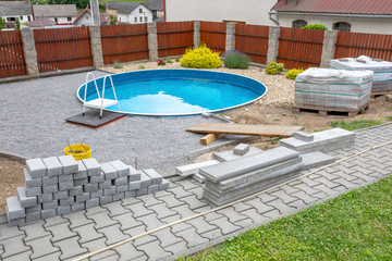 Swimming pool under construction, replacing interlocking pavement in rural country house