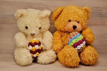 teddy bears with easter eggs on wooden background
