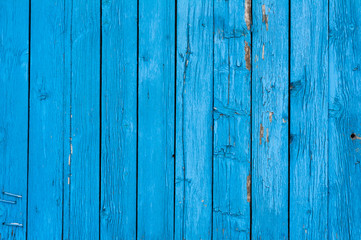 Fototapeta na wymiar Bringt blue old painted vertical wooden planks. Abstract vintage wood background texture or banner.