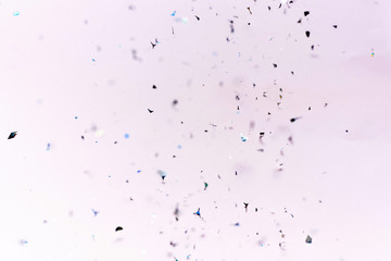 Flying silver confetti on a purple background. Template for advertising, blog or text. Festive...