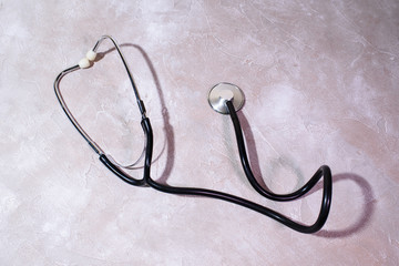 Stethoscope on a concrete texture. Health care.