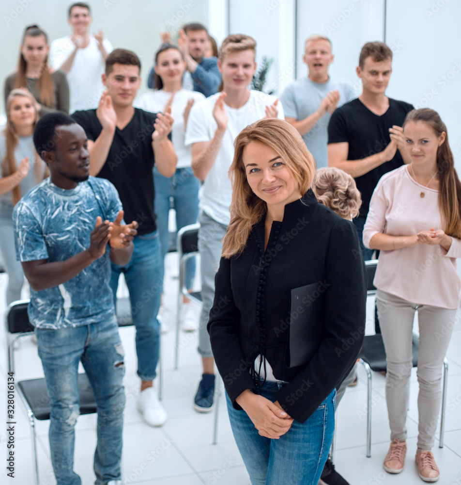 Wall mural top view. a group of casual young people applauding together